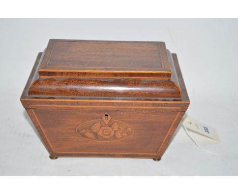 A 19th Century inlaid mahogany sarcophagus shaped former tea caddy, the hinged cover opening to reveal baize lined interior.