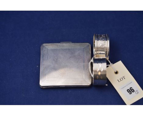 An Elizabeth II silver compact, by Kigu Ltd., London 1955, with  engine turned decoration; together with two silver napkin ri