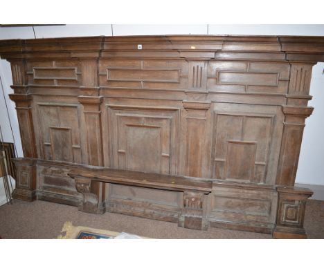 A late 19th Century oak panel, flared cornice above three sections of geometric moulds and matching base piece, the shelf wit