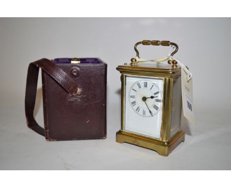 A brass cased carriage clock with bevelled glass panels, with visible escapement, contained in a morocco leather case.