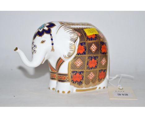 A large modern Royal Crown Derby ceramic paperweight in the form of an elephant with gold stopper.