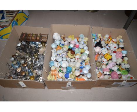 Egg cups, various designs in ceramic and metal, in three boxes.