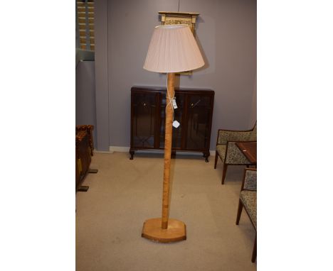 An Art Deco standard lamp in maple veneer.