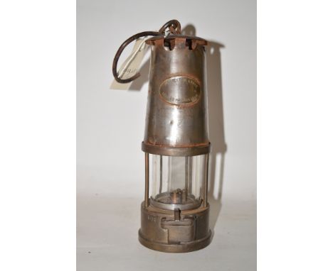 A miner's lamp by The Protector Lamp Company, Manchester.