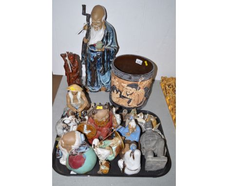 Ceramic figurines; a carved wooden figure; and a ceramic planter.