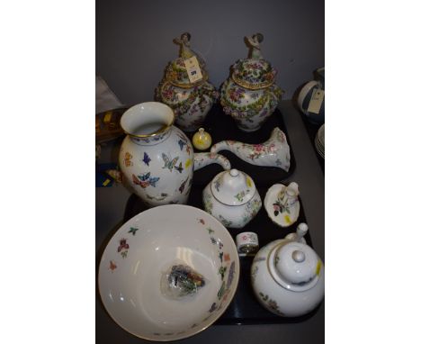 A pair of Continental ceramic urn pattern vases with covers, with hand-painted floral decoration and applied flowers; a pair 