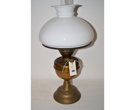 An early 20th Century table oil lamp with opaque glass shade.