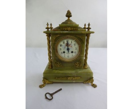 An Onyx and gilt metal mantle clock, two train movement, Arabic numerals and enamel dial, to include key and pendulum