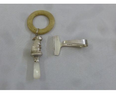 A childs silver and mother of pearl teething ring and a silver pusher