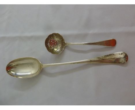 A Scottish silver basting spoon by Hamilton and Inches and a silver caddy spoon