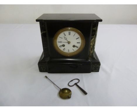 A black slate mantle clock, two train movement, white enamel dial and Roman numerals, to include key and pendulum