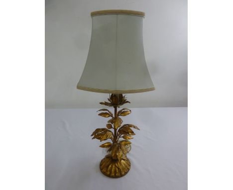 A gilt metal table lamp in the form of a stylised leafy plant with silk shade