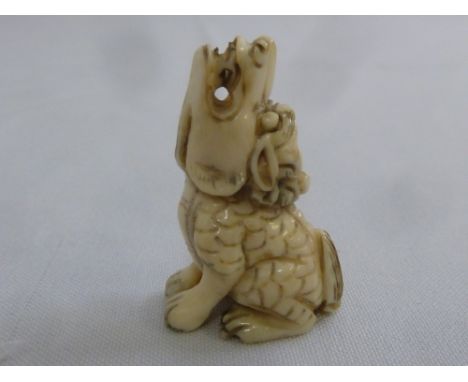 Late 19th century ivory netsuke of a seated dragon