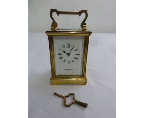 Mappin and Webb brass carriage clock with white enamel dial, Roman numerals and swing handle to include key