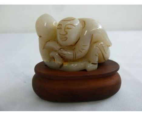 Chinese 19th century mutton fat jade figurine of a boy on a hardwood base