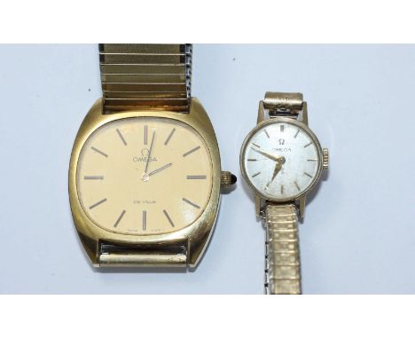 A 9ct gold cased ladies Omega wristwatch on expanding bracelet, together with a gents gold-plated Omega De Ville wristwatch.