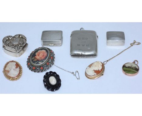 An early 20th century silver vesta case together with three silver pill boxes, two 9ct gold-framed cameo brooches, .800 grade