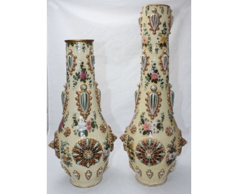 A pair of Zsolnay vases of ovoid form with cylindrical necks, floral decoration and applied pierced jewelling, marked 3374 to