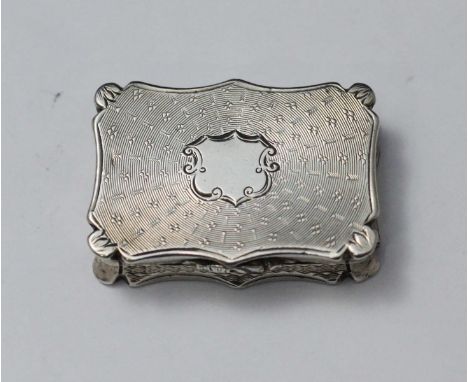 A Victorian silver and silver-gilt vinaigrette by Nathaniel Mills, of serpentine-rectangular form with engine-turned decorati