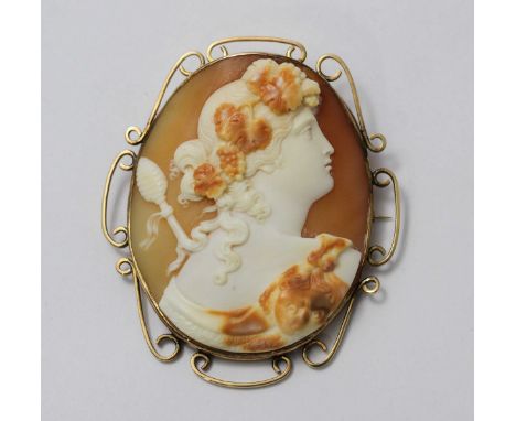 A nice quality Italian shell-carved cameo brooch depicting a female follower of Bacchus, God of Wine, carved with fruiting gr