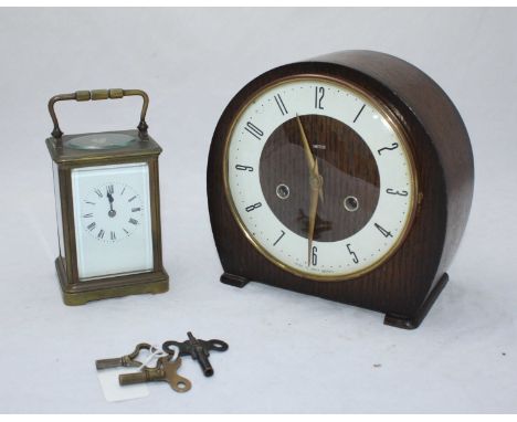 A brass carriage clock, the white dial with Roman numerals denoting hours and exposed platform escapement, together with a Sm