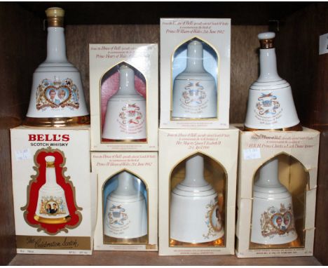 Four 75cl bottles of Bell's Scotch Whisky and four 50cl bottles, issued in bell-shaped pottery decanters by Wade, issued as R