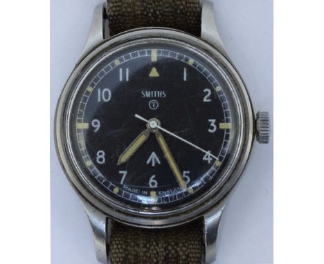 A Smiths W10 manual wind military issue wristwatch, c.1968. The black dial with Arabic numerals, luminous hour markers, broad