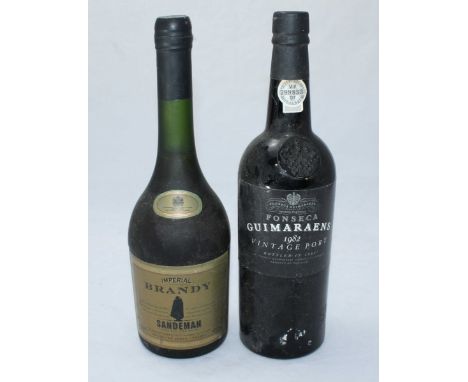 A bottle of Guimaraens 1982 Vintage Port, together with a bottle of Sandeman Imperial Brandy