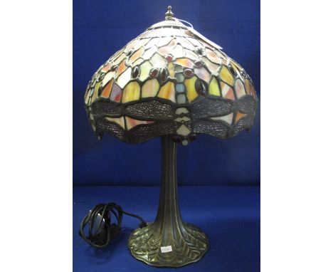 Medium sized Tiffany style table lamp, having bronzed metal base and dragonfly design multicoloured shade. 50cm high approx.(