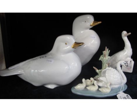 Group of ceramic bird ornaments to include: Lladro porcelain swan and cynets group; Nao porcelain white duck and two Hungaria