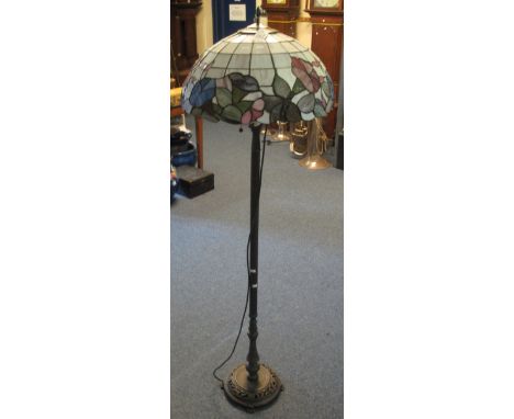 Tiffany style standard lamp and shade, with reeded, bronzed main support on circular, florally pierced base with floral shade