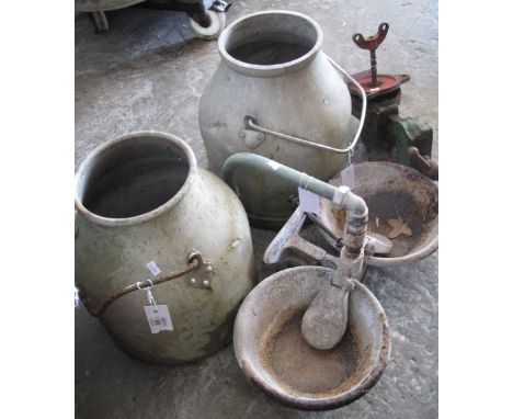 Two vintage aluminium churns together with double water bowls and a bench vice.  (4)(B.P. 24% incl. VAT)