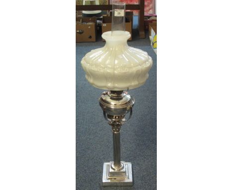 Plated metal Corinthian column oil lamp with plated reservoir, white glass fluted shade and clear chimney.  85cm high overall