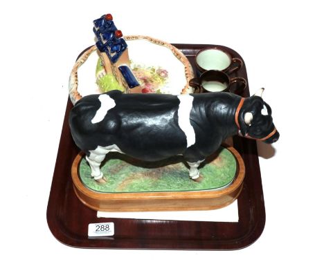 A Royal Worcester porcelain figure of a Holstein-Friesian bull by Doris Lindner, with stand and certificate; a Staffordshire 