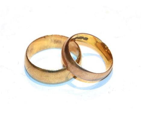 A 12 carat gold band ring, finger size K; and a band ring, stamped '18K', finger size N1/2.  12 carat gold ring - 2.76 grams.