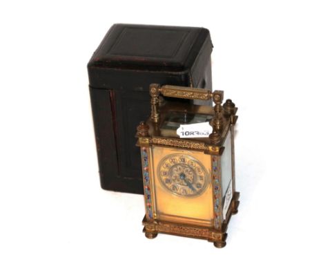 A French brass and champleve enamel carriage timepiece circa 1900 with fitted travelling case  . Side glass panels and back d