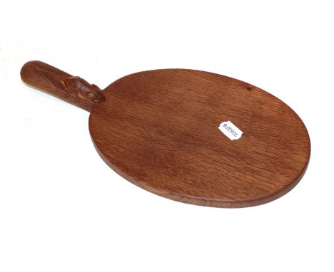 Workshop of Robert 'Mouseman' Thompson, an oval oak cheese board with carved mouse signature 