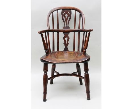 AN EARLY 19TH CENTURY POSSIBLY WELSH BORDERS, CHILD'S ARMCHAIR, with double comb back, elm seat and yew wood back, supported 