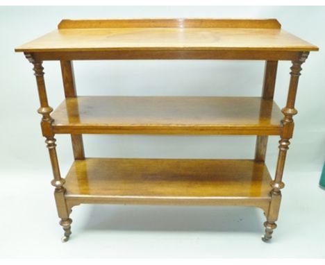 A LATE 19TH CENTURY OAK FINISHED THREE TIER BUFFET with turned and blocked fore supports, plain rear, with white ceramic cast