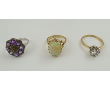 A 9CT GOLD OPAL SET RING together with two costume jewellery rings (3) 