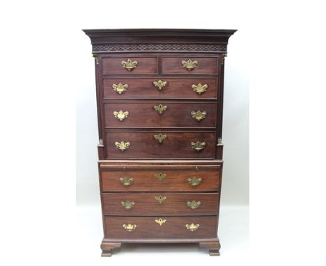 A GEORGE III MAHOGANY CHEST ON CHEST, blind fret frieze, the top section with quarter column decorative mounts, with brushing