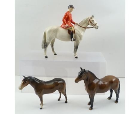 A BESWICK HUNTSMAN on a dapple grey horse, model 1501, gloss finish, 21cm high, together with a DARTMOOR PONY and one other B