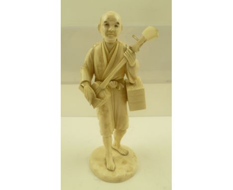 A MEIJI PERIOD IVORY OKIMONO, Japanese c.1910, a male figure playing shamisen, signed in a recessed red cartouche to the base