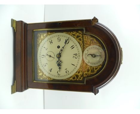 A GEORGIAN DESIGN MAHOGANY CASED MANTEL CLOCK, the case with brass handle and pierced fish scale grilles, raised on brass oge