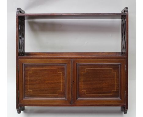 AN EDWARDIAN MAHOGANY WALL MOUNTING CUPBOARD/SHELF UNIT, having pierced decoration, 56cm wide 