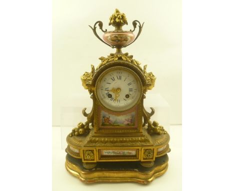 A LATE 19TH CENTURY FRENCH GILT METAL CASED MANTEL CLOCK, inset painted Sevres style ceramic panels, with circular enamel dia