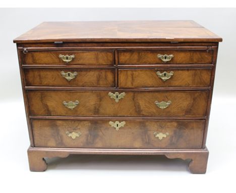 A GEORGE III WALNUT CHEST OF DRAWERS having two pairs of short drawers over two long drawers, brass handles on bracket feet, 