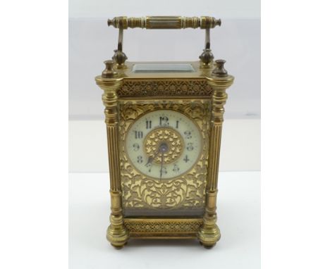 A FRENCH BRASS CASED CARRIAGE CLOCK, circa 1900, the case with floral lattice borders, circular dial with Arabic numerals ami