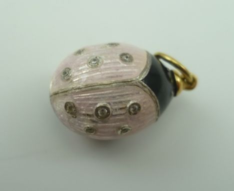 A RUSSIAN PENDANT EGG, pink and black enamel, decorated as a Ladybird style insect, stone inset, the suspension ring stamped 