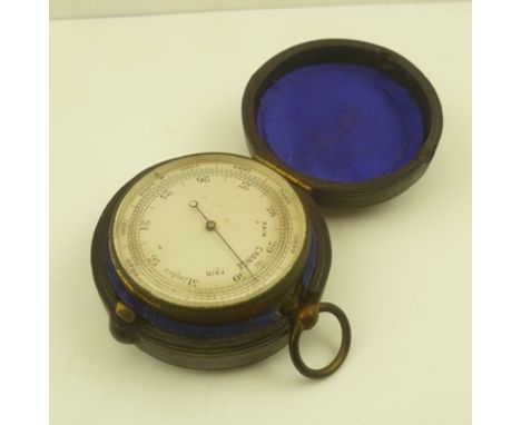 AN EARLY 19TH CENTURY POCKET BAROMETER, calibrated, silvered dial in a fabric lined Morocco leather outer case, diameter of b